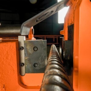 Rebar positioned inside hydraulic shear blades before cutting